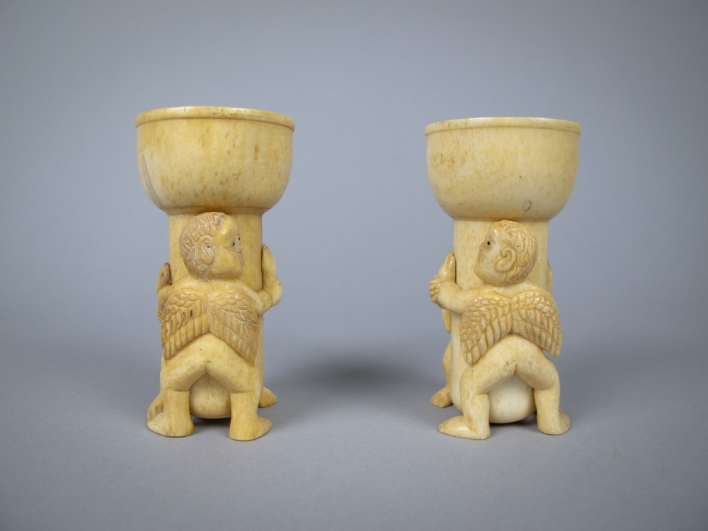 Unusual Pair of 19th Century Carved Bone Cherub Candle Holders. View III