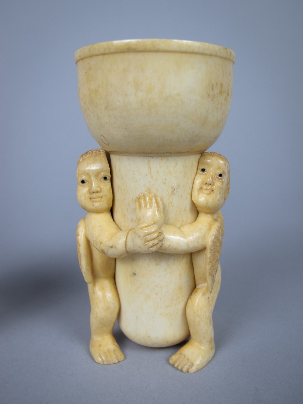 Unusual Pair of 19th Century Carved Bone Cherub Candle Holders. View V