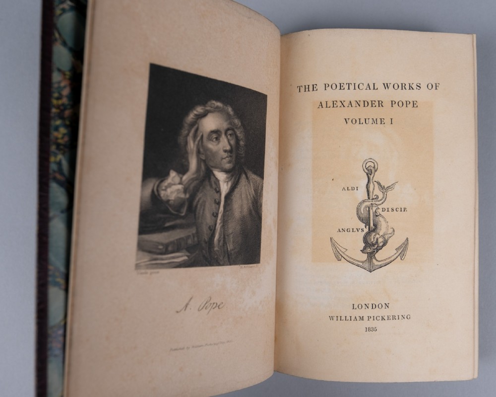 A three-volume set of 1835 leather-bound books by Alexander Pope with dark spine labels and gilt lettering. View IX
