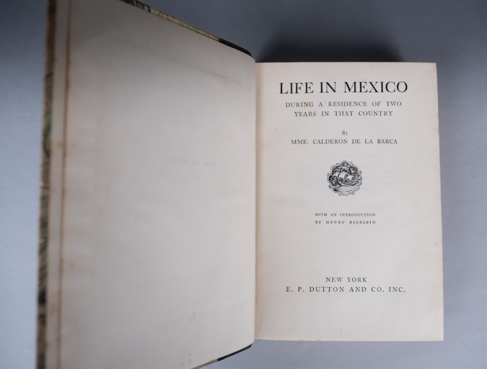 A half-leather bound book titled Life In Mexico with a dark brown spine featuring gilt geometric patterns and marbled paper boards. View X