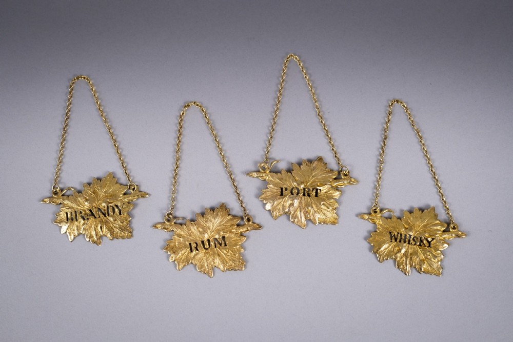 Four Silver Gilt Vine Leaf Decanter Labels by SMD, London, 1968.