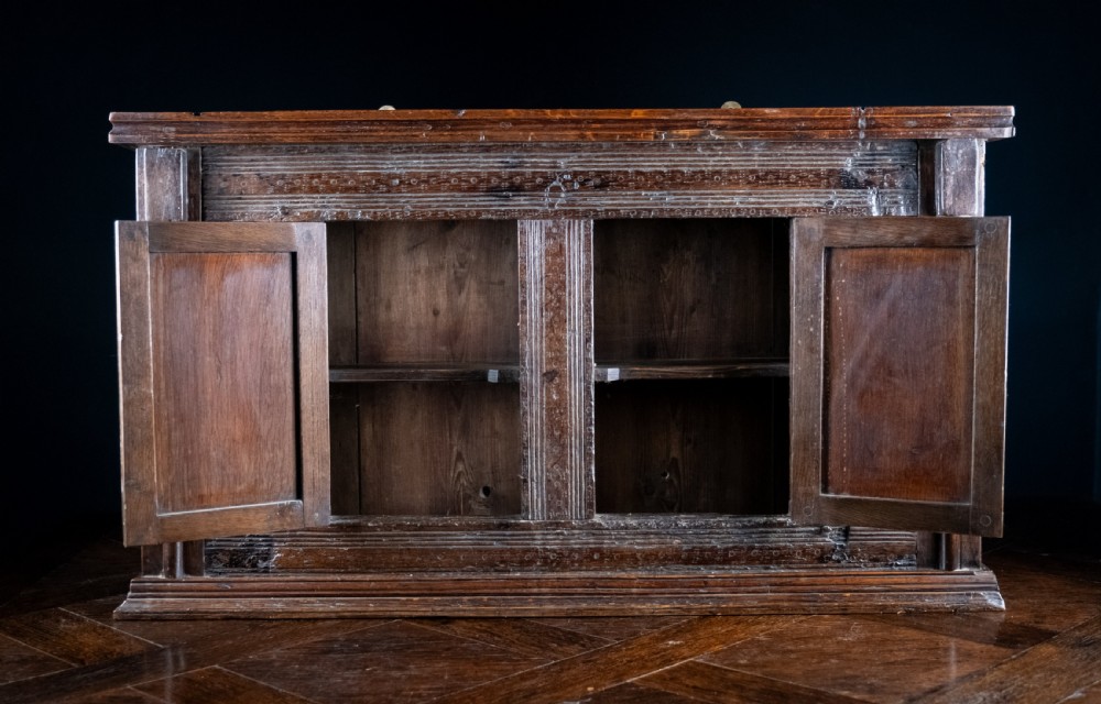 A rectangular eighteenth-century oak wall cupboard featuring double panelled doors, geometric mouldings, and turned corner columns. View IV