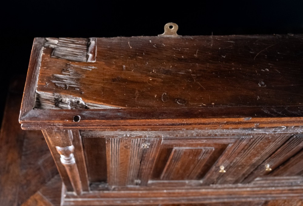 A rectangular eighteenth-century oak wall cupboard featuring double panelled doors, geometric mouldings, and turned corner columns. View VIII