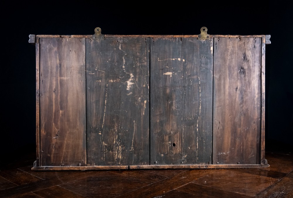 A rectangular eighteenth-century oak wall cupboard featuring double panelled doors, geometric mouldings, and turned corner columns. View XIV