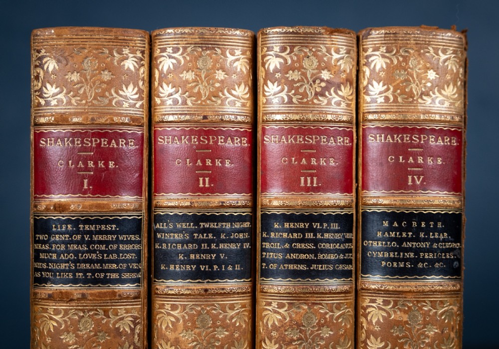 A four-volume set of 1881 Shakespeare leather-bound books standing upright, featuring heavily gilt-tooled spines with red and black title labels. View II