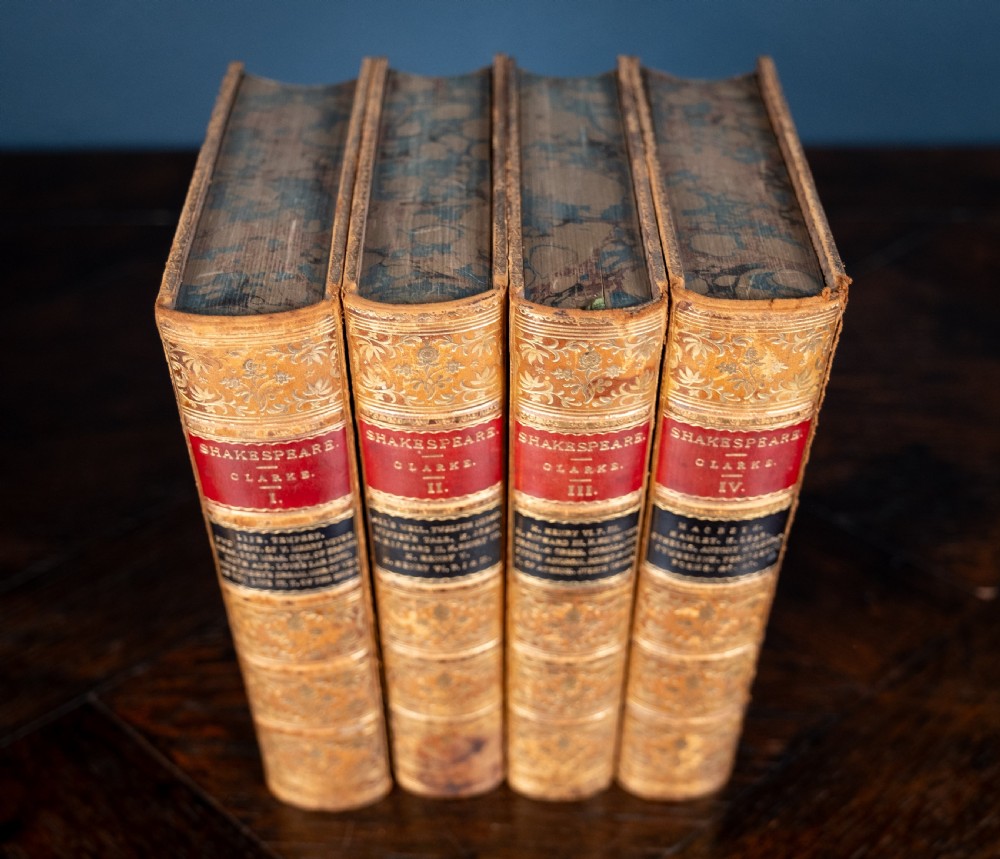 A four-volume set of 1881 Shakespeare leather-bound books standing upright, featuring heavily gilt-tooled spines with red and black title labels. View III