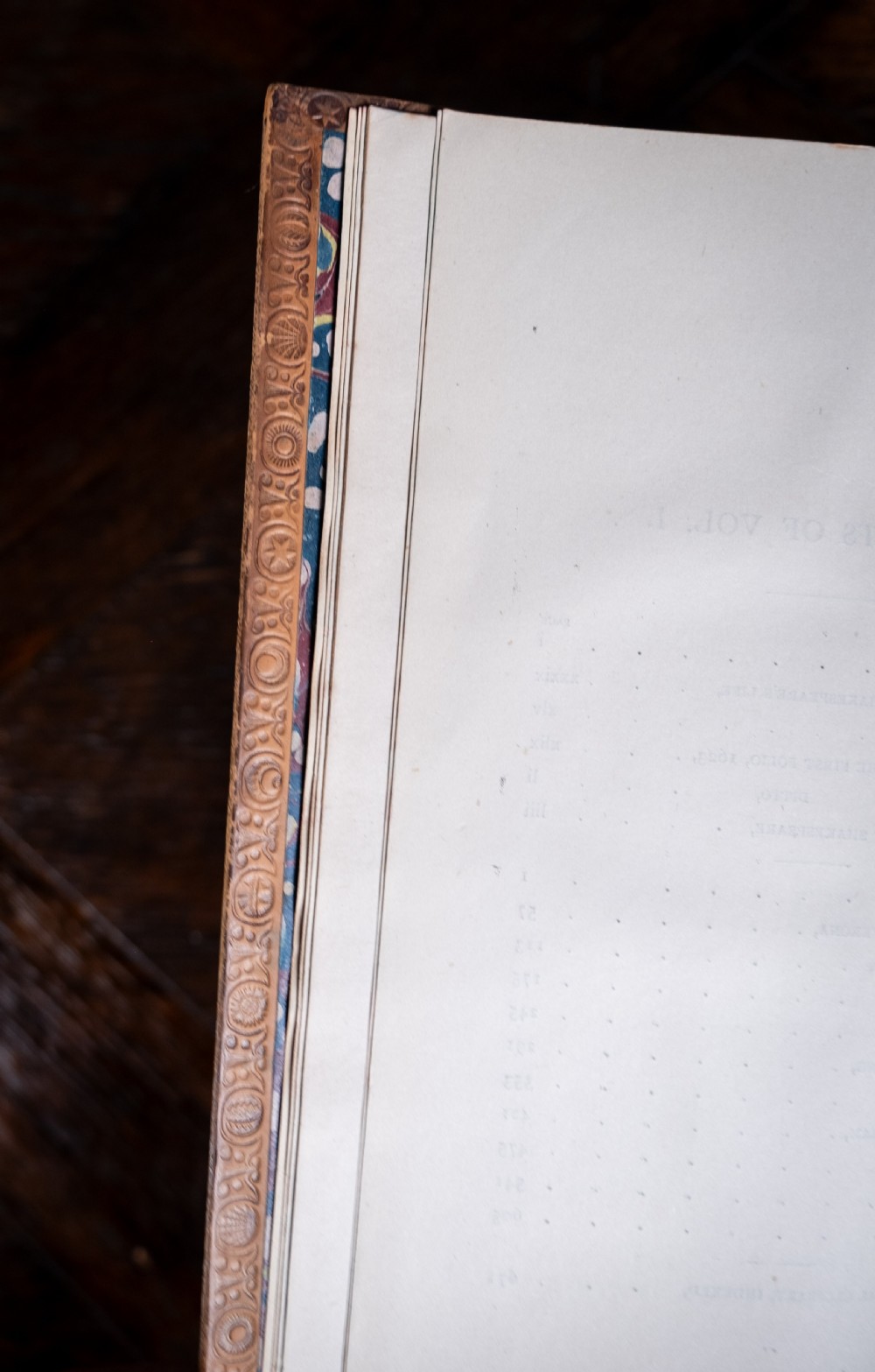 A four-volume set of 1881 Shakespeare leather-bound books standing upright, featuring heavily gilt-tooled spines with red and black title labels. View XII