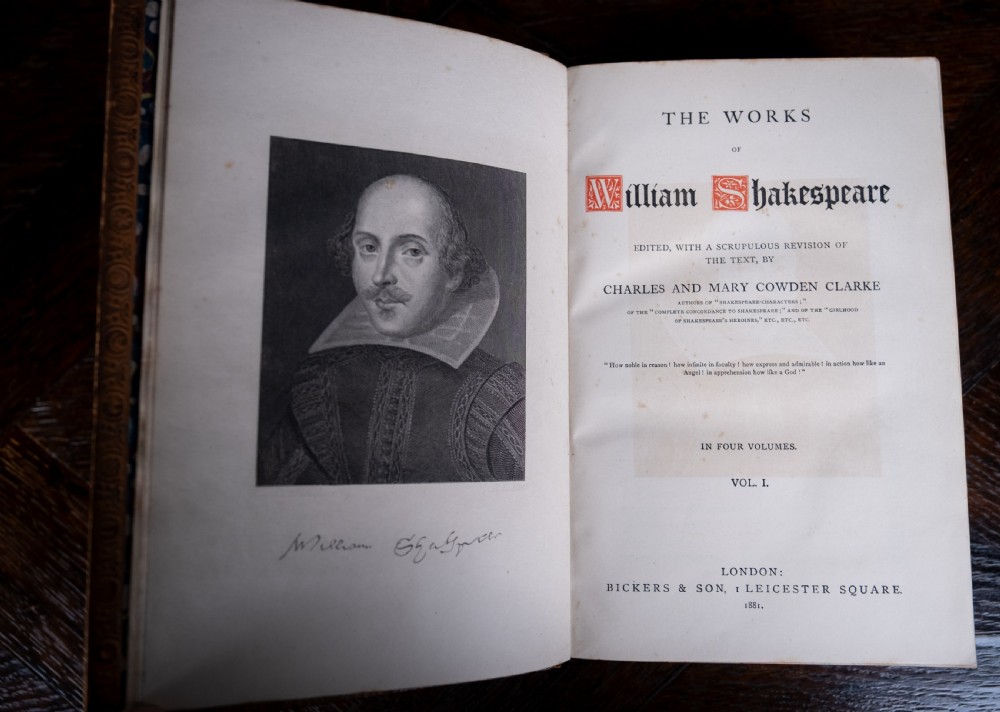 A four-volume set of 1881 Shakespeare leather-bound books standing upright, featuring heavily gilt-tooled spines with red and black title labels. View XIV