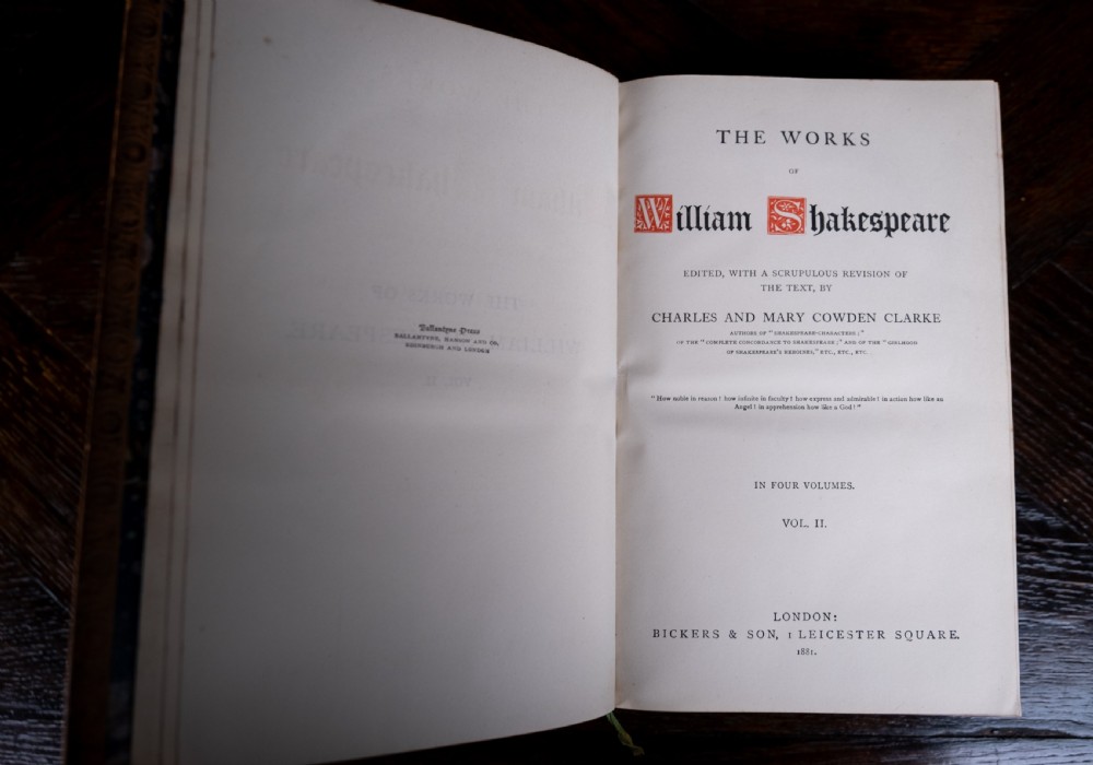 A four-volume set of 1881 Shakespeare leather-bound books standing upright, featuring heavily gilt-tooled spines with red and black title labels. View XVII