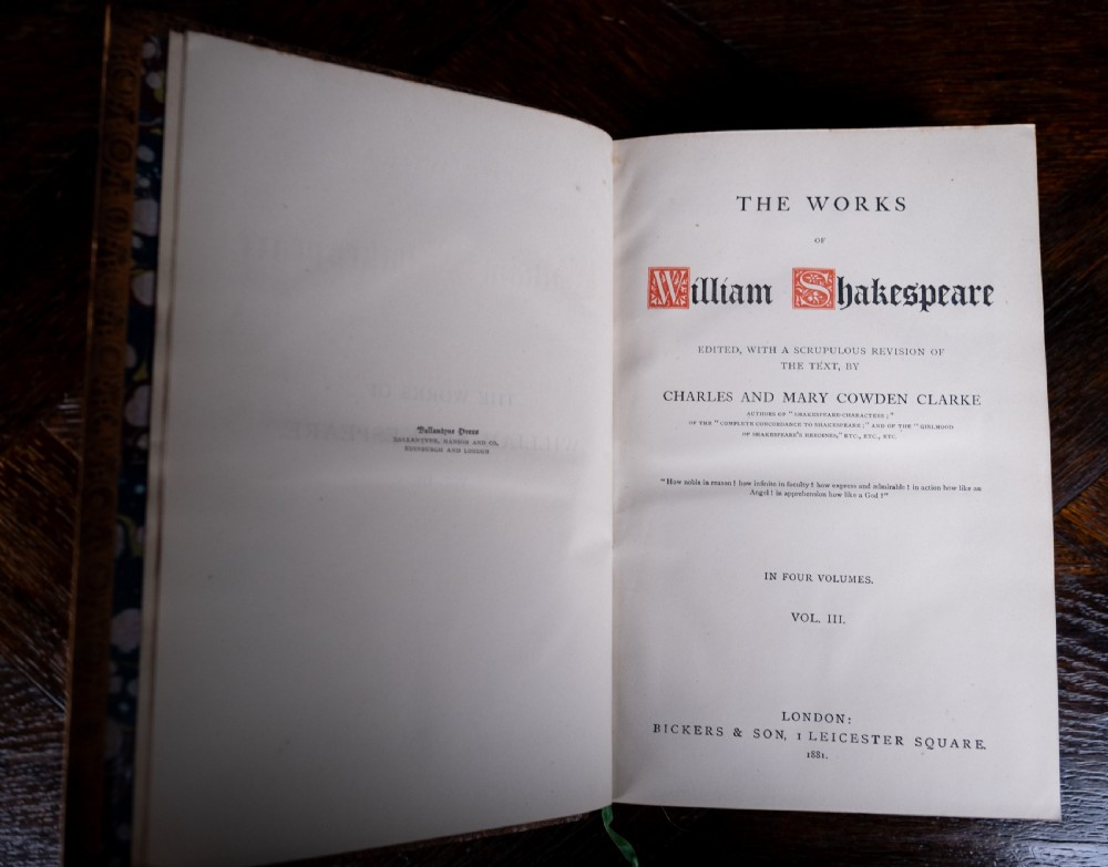 A four-volume set of 1881 Shakespeare leather-bound books standing upright, featuring heavily gilt-tooled spines with red and black title labels. View XVIII