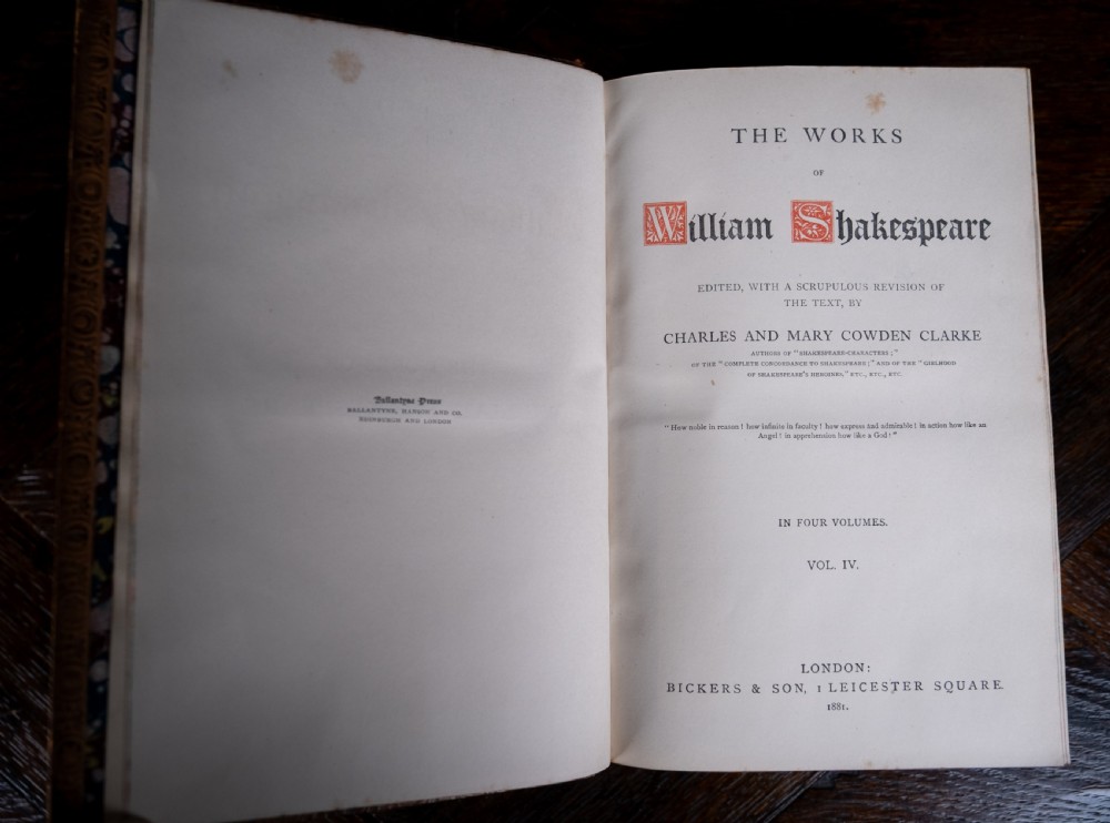 A four-volume set of 1881 Shakespeare leather-bound books standing upright, featuring heavily gilt-tooled spines with red and black title labels. View XIX