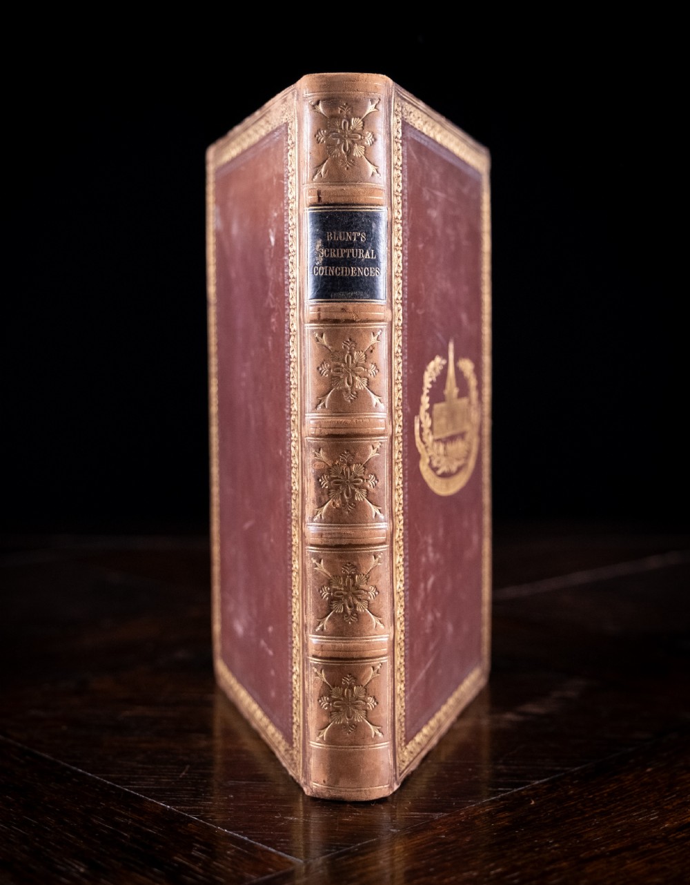 A 1850 Victorian leather-bound book featuring gold gilt floral tooling on the spine and a black title label.