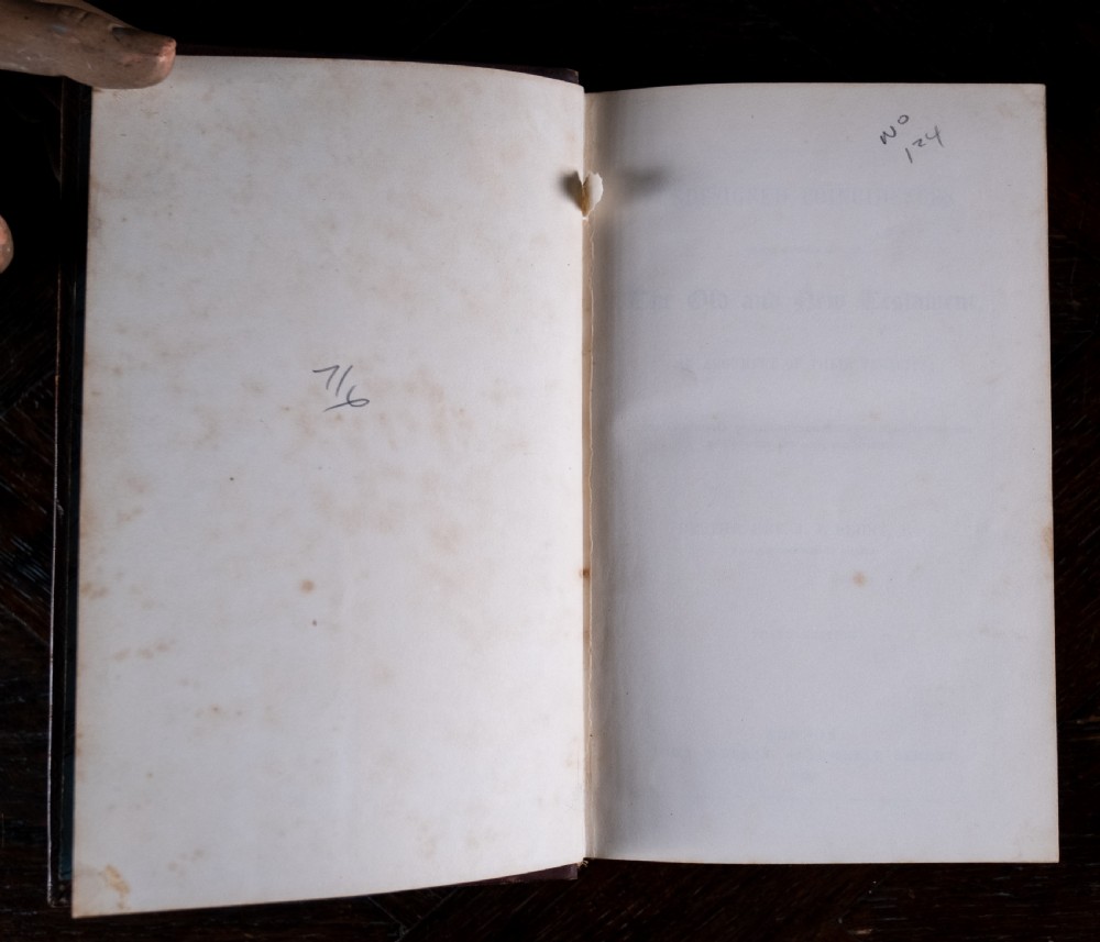 A 1850 Victorian leather-bound book featuring gold gilt floral tooling on the spine and a black title label. View VII
