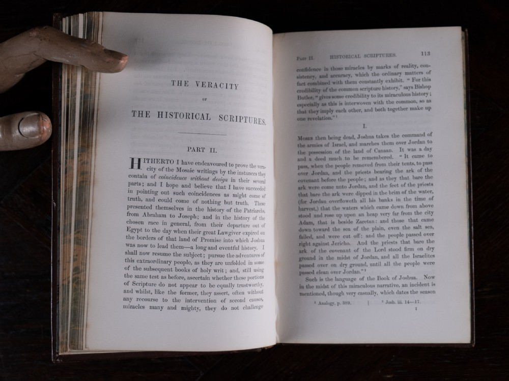 A 1850 Victorian leather-bound book featuring gold gilt floral tooling on the spine and a black title label. View XI