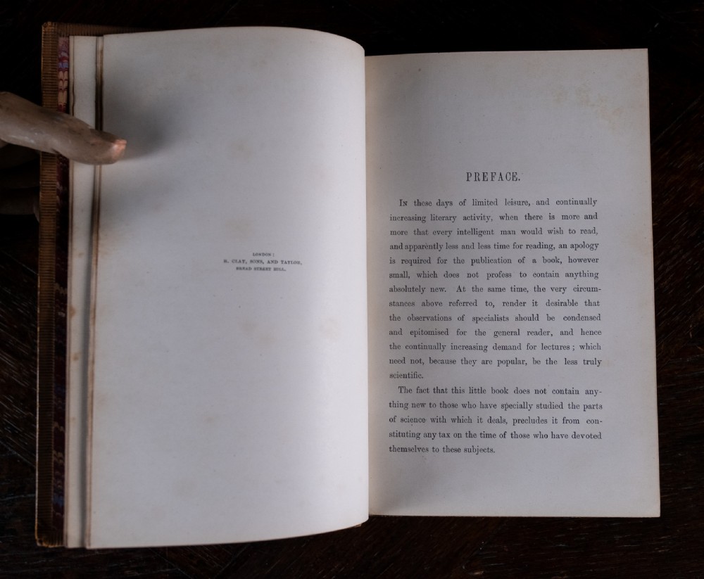 A nineteenth-century tan leather-bound book featuring ornate gilt tooling on the spine and an embossed coat of arms on the front cover. View VIII
