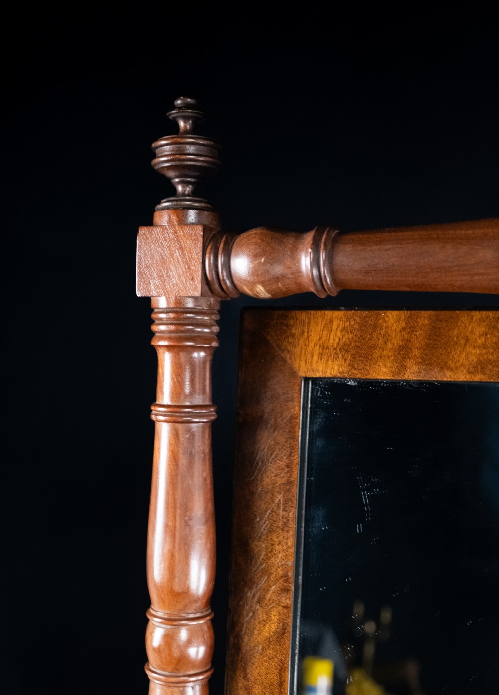 A full-length 19th-century mahogany cheval mirror featuring a rectangular swivelling glass plate within a turned wooden frame supported by splayed legs with brass castors. View VIII