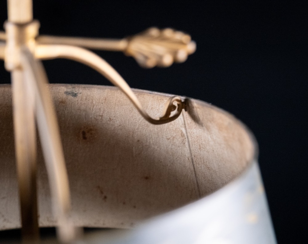A gilt brass bouillotte lamp featuring a dark adjustable shade and three candle-style lights on a circular tray base. View III