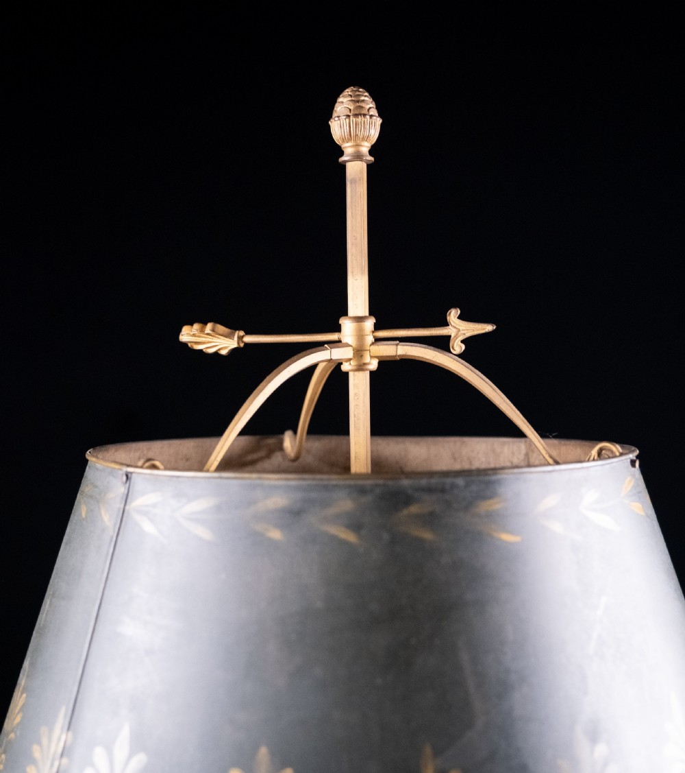 A gilt brass bouillotte lamp featuring a dark adjustable shade and three candle-style lights on a circular tray base. View XI