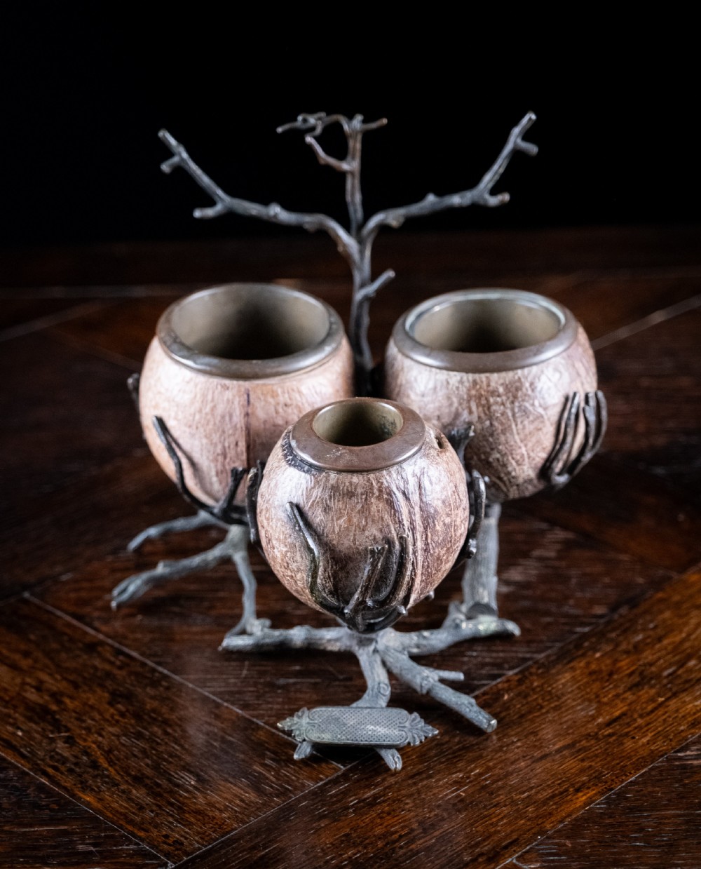 A Victorian bronze and coconut shell table vesta featuring three carved coconut vessels supported by cast metal branch mounts. View II