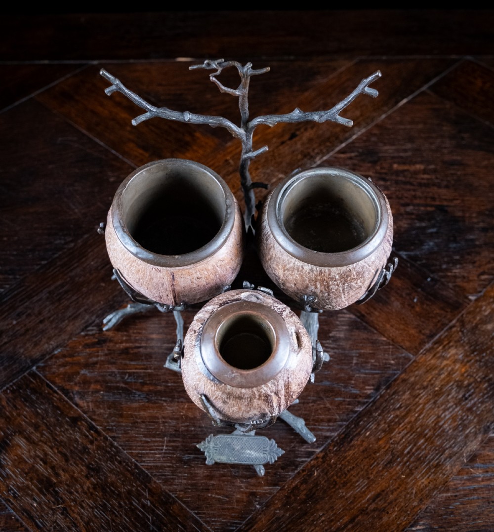 A Victorian bronze and coconut shell table vesta featuring three carved coconut vessels supported by cast metal branch mounts. View VII