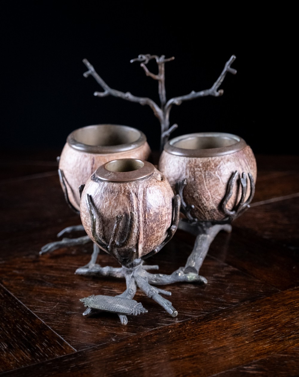 A Victorian bronze and coconut shell table vesta featuring three carved coconut vessels supported by cast metal branch mounts. View VIII