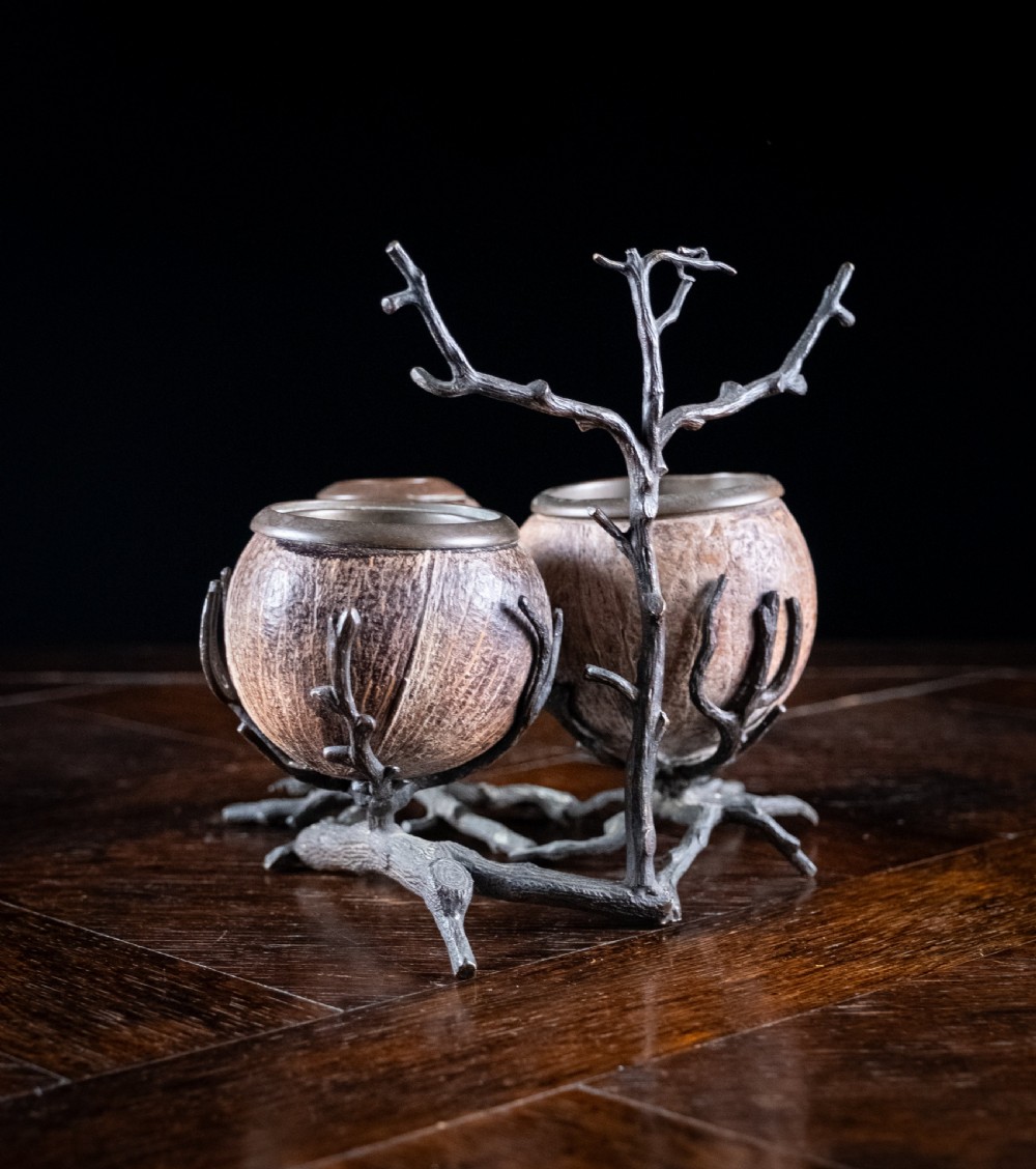 A Victorian bronze and coconut shell table vesta featuring three carved coconut vessels supported by cast metal branch mounts. View X