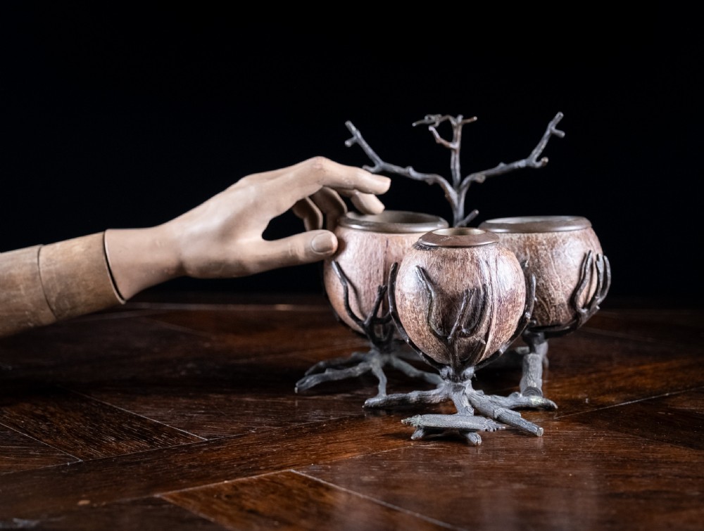 A Victorian bronze and coconut shell table vesta featuring three carved coconut vessels supported by cast metal branch mounts. View XIV