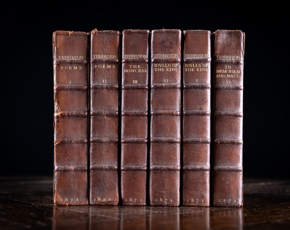 A six-volume set of Victorian brown leather-bound books featuring gilt spine lettering and raised bands.