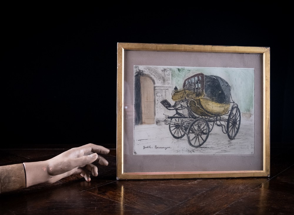 A framed 1911 etching by Ludwig Michalek depicting Goethes travelling carriage set within a gilt wood frame. View IX