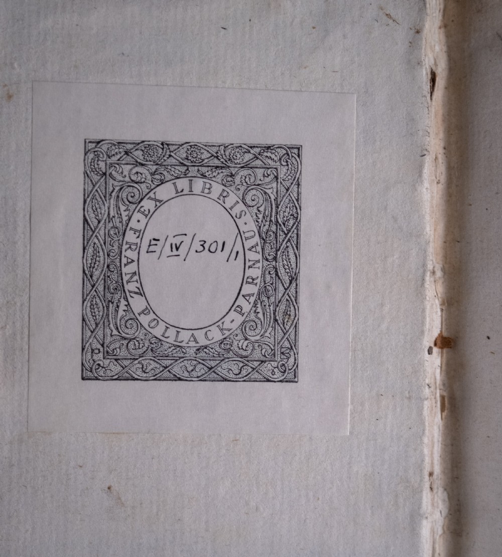 A two-volume set of eighteenth-century brown leather-bound books standing vertically with gold-tooled spine titles. View VII