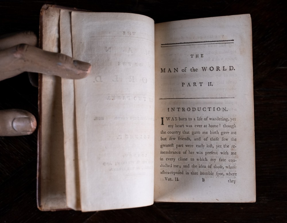 A two-volume set of eighteenth-century brown leather-bound books standing vertically with gold-tooled spine titles. View XIII