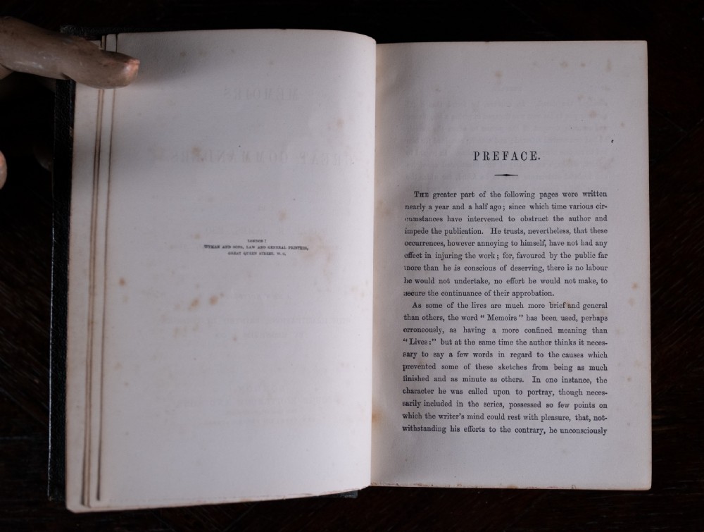 An antique Victorian book standing vertically, featuring green leather covers with gilt border lines and a dark brown spine detailed with gold-tooled compartments. View IX