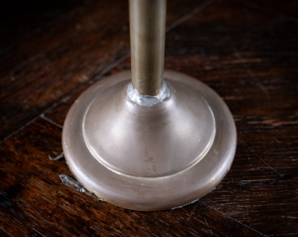 An antique Edwardian brass magnifying glass featuring an adjustable articulated arm and a circular weighted base. View IX