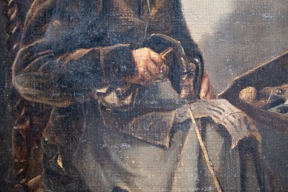 A 19th-century oil painting depicting a seated cobbler working at a bench, encased within an ornate gilded frame with shell corner detailing. View IV