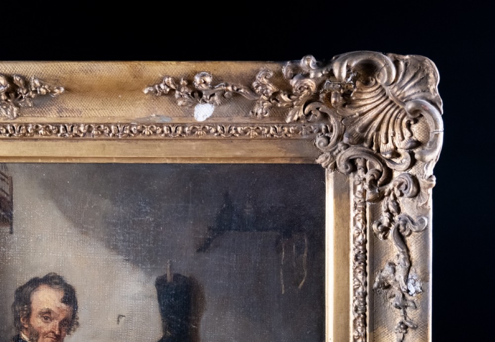 A 19th-century oil painting depicting a seated cobbler working at a bench, encased within an ornate gilded frame with shell corner detailing. View VIII