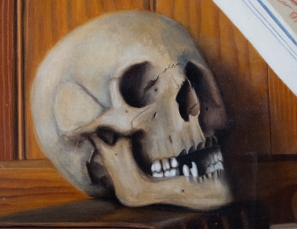 An oil painting depicting a human skull resting on a bound book alongside an artist palette, brushes, and a pinned sketch against a vertical timber panel background. View III