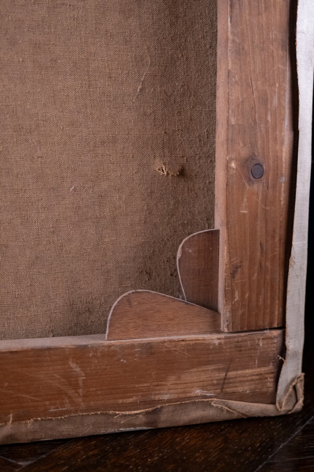 An oil painting depicting a human skull resting on a bound book alongside an artist palette, brushes, and a pinned sketch against a vertical timber panel background. View XV