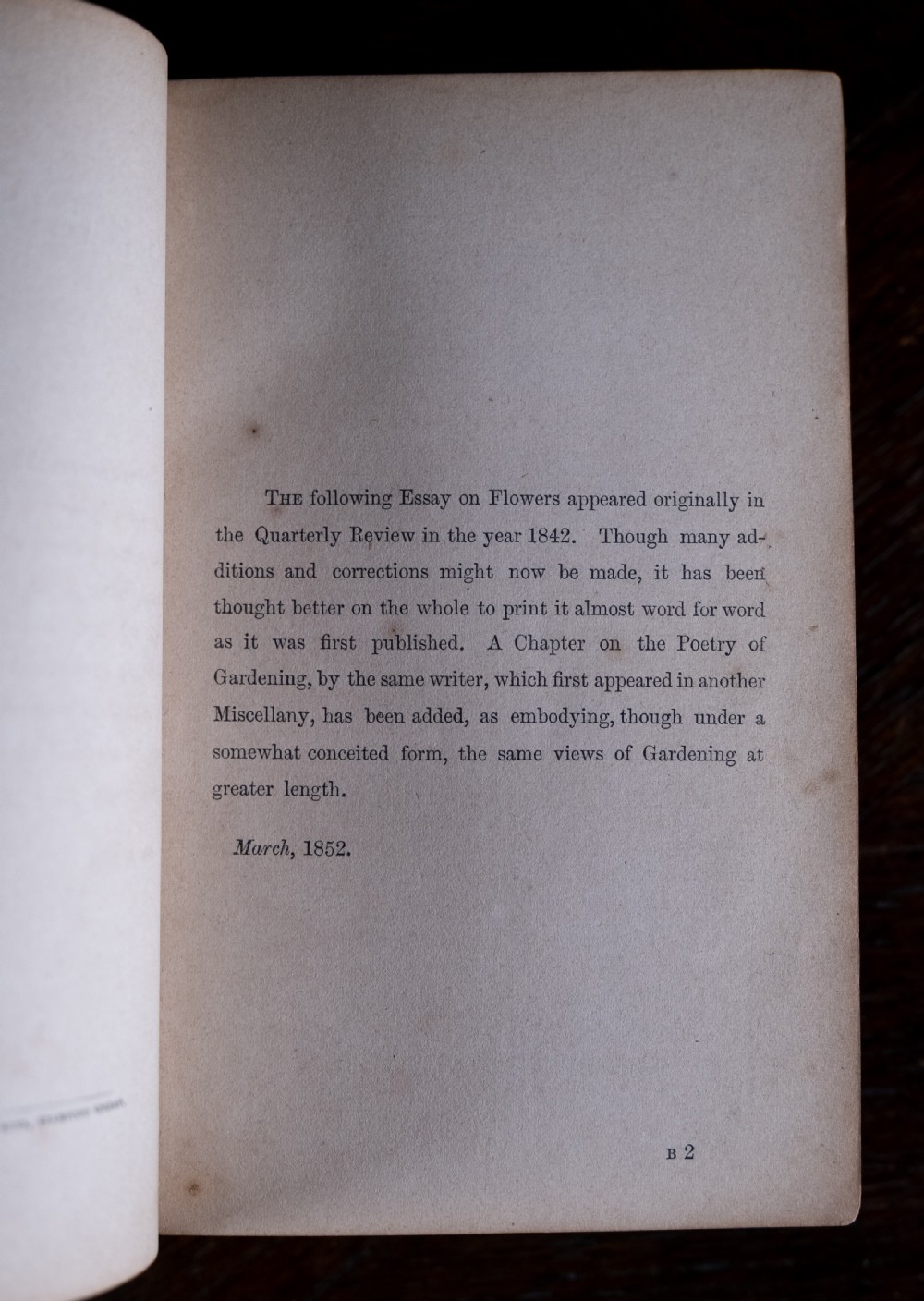 A Victorian red leather-bound book featuring detailed gold leaf tooling on the spine and covers standing upright. View IX