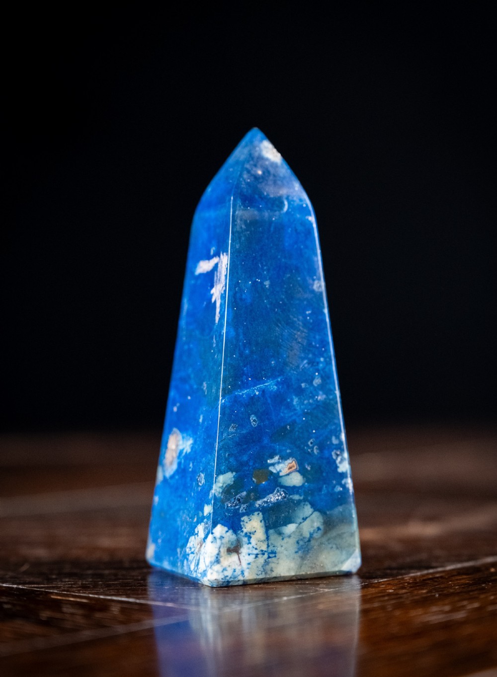A polished deep blue lapis lazuli obelisk engraved with gilt text reading Interlacken 1876 near the base. View VI