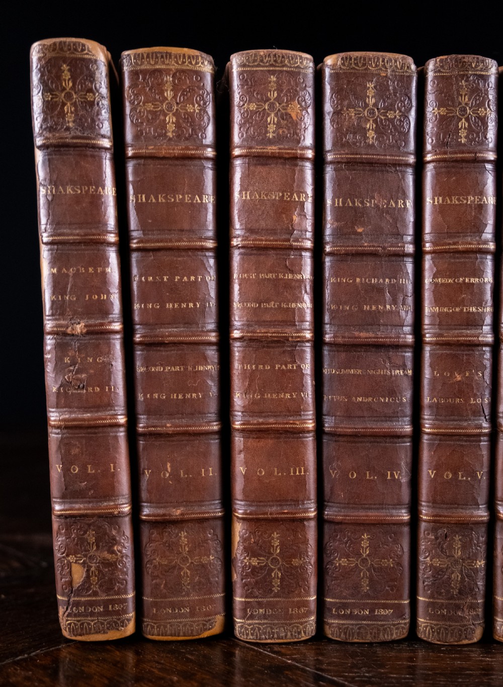 A complete twelve-volume set of brown leather-bound books printed in 1807 with gold-tooled decorative spines. View III