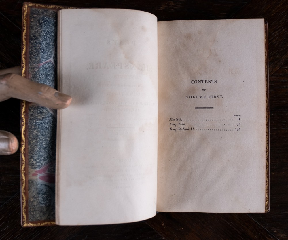 A complete twelve-volume set of brown leather-bound books printed in 1807 with gold-tooled decorative spines. View XVII