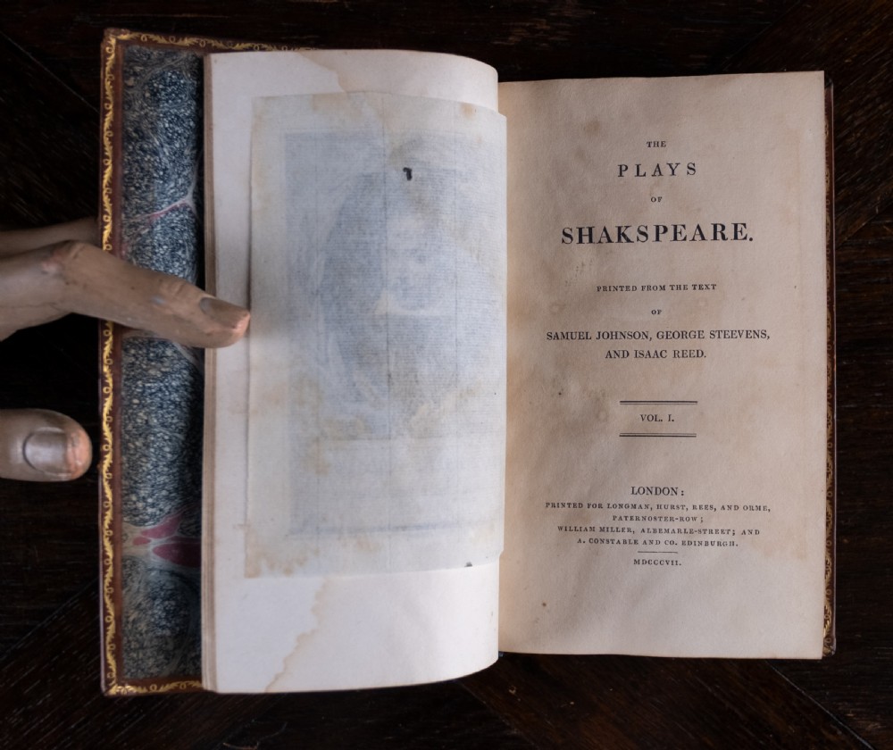 A complete twelve-volume set of brown leather-bound books printed in 1807 with gold-tooled decorative spines. View XXVII