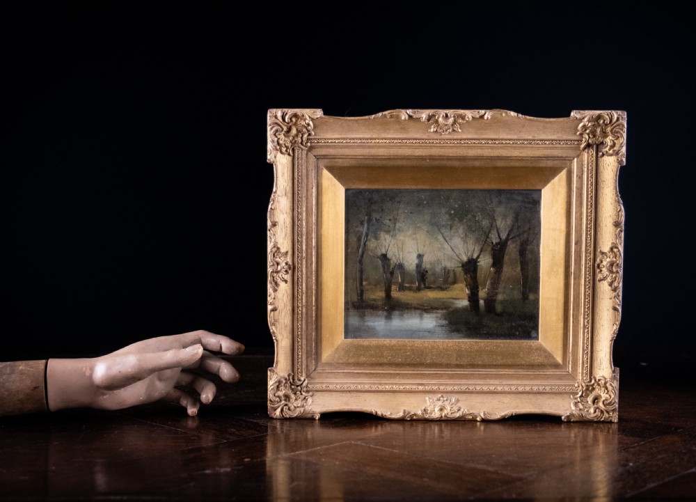 A 19th-century oil painting on board depicting a figure amidst pollarded willow trees along a riverbank in muted earth tones. View VI