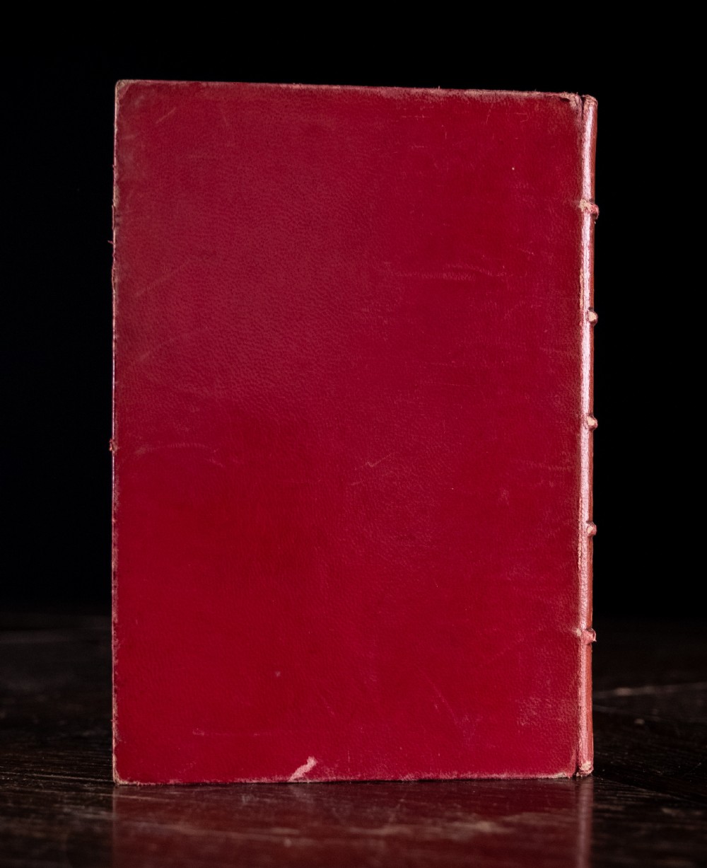 A red leather-bound edition of Lays of Ancient Rome by Macaulay, featuring raised spine bands and gilt lettering. View IV