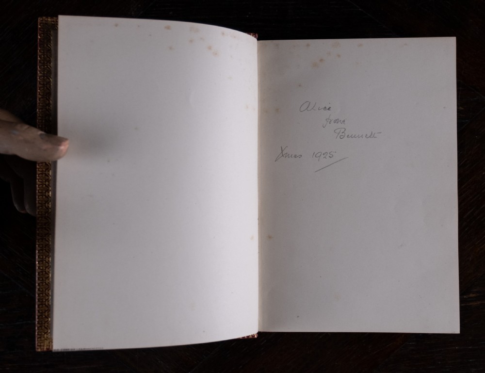 A red leather-bound edition of Lays of Ancient Rome by Macaulay, featuring raised spine bands and gilt lettering. View VII
