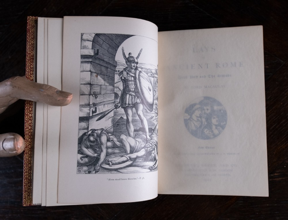 A red leather-bound edition of Lays of Ancient Rome by Macaulay, featuring raised spine bands and gilt lettering. View IX
