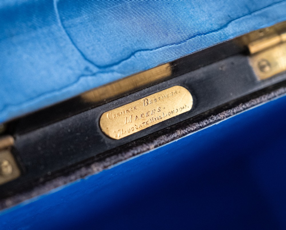 A Victorian domed coromandel wood casket featuring a central blue jasperware cameo medallion set within engraved brass mounts and a twisted brass border. View VII