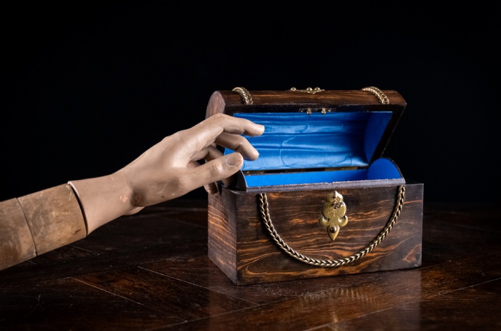 A Victorian domed coromandel wood casket featuring a central blue jasperware cameo medallion set within engraved brass mounts and a twisted brass border. View XIV