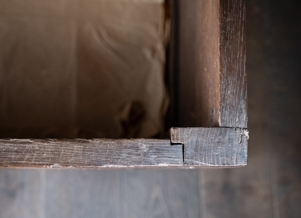 A 17th-century dark oak coffer featuring three carved panels with a central lion motif and geometric rosettes. View XIX