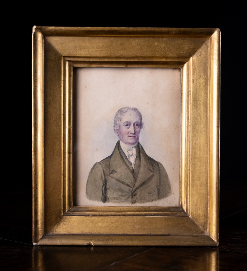 A pair of early 19th-century watercolour portrait paintings featuring a gentleman and a lady set within thick moulded giltwood frames. View II